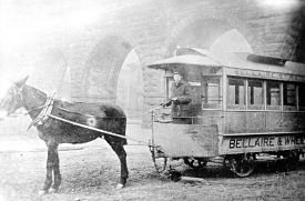 mule pulling trolley-like car with Bellaire& Wheeling on the side; in front of the Wheeling Stone Viaduct