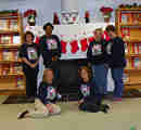 photo of staff members in front of the fireplace