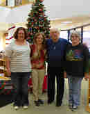 staff members in front of the Christmas Tree